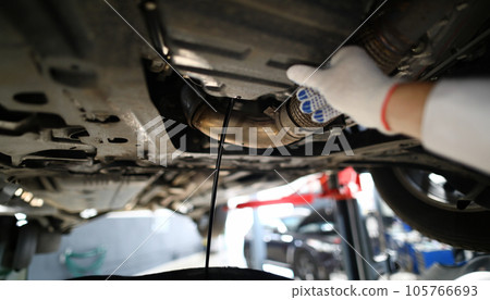 Black jet of used engine oil drains from the engine Black jet of used engine oil drains from the engine 105766693