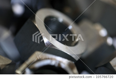 Set of shiny metal screw nuts lying in box 105766720