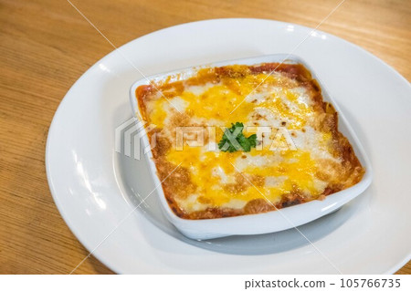 Lasagna served in a bowl on the table 105766735