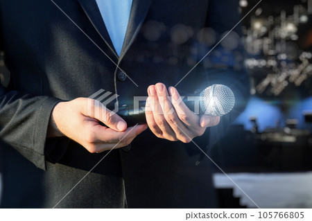 A man holds a microphone. A man holds a microphone. 105766805