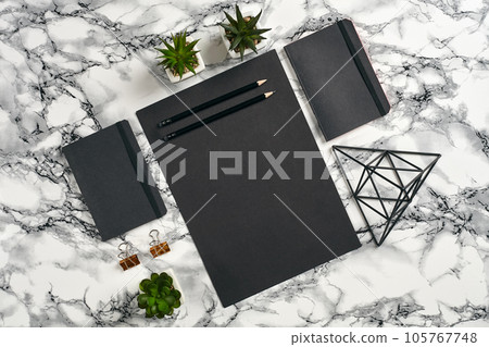 Top view in focus with different office equipment, supplies, stationery. Marble table with copy space. Education, workplace background. Close-up. Top view in focus with different office equipment, supplies, stationery. Marble table with copy space. Education, workplace background. Close-up. 105767748