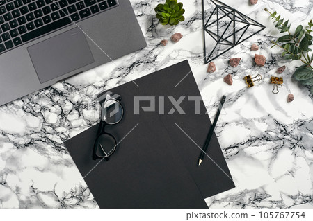 Top view in focus with different office equipment, supplies, stationery. Marble table with copy space. Education, workplace background. Close-up. 105767754