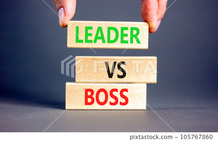 Boss vs leader symbol. Concept words Boss vs versus leader on wooden block. Beautiful grey table grey background. Businessman hand. Business motivational boss vs leader concept. Copy space. Boss vs leader symbol. Concept words Boss vs versus leader on wooden block. Beautiful grey table grey background. Businessman hand. Business motivational boss vs leader concept. Copy space. 105767860