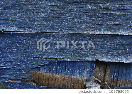 The surface of old rotten boards. Cracks in the wood. Old plywood. Traces of paint. The surface of old rotten boards. Cracks in the wood. Old plywood. Traces of paint. 105768065