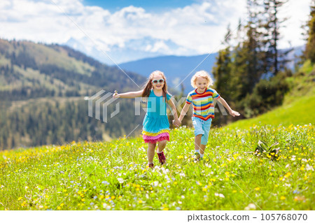 Children hiking in Alps mountains. Kids outdoor. 105768070