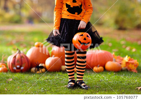Kids with pumpkins in Halloween costumes 105768077
