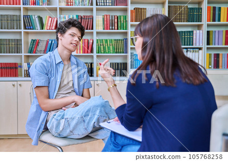 Young guy student at meeting with psychologist, college counselor in office Young guy student at meeting with psychologist, college counselor in office 105768258