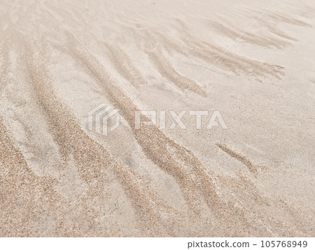 Sand texture. Sandy beach for background. Top view. Natural sand stone texture background. sand on the beach as background. Wavy sand background for summer designs. 105768949