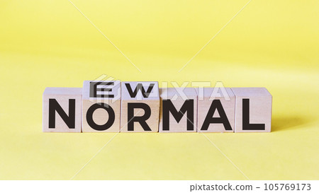 NEW PLAIN text on wooden cube and yellow background. New normal life after covid-19 pandemic NEW PLAIN text on wooden cube and yellow background. New normal life after covid-19 pandemic 105769173