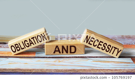 OBLIGATION AND NECESSITY text on wooden blocks and colorful background. OBLIGATION AND NECESSITY text on wooden blocks and colorful background. 105769197