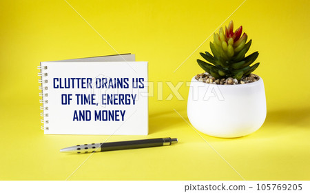 clutter takes time, energy and money away from us, clutter free concept - text on notepad  105769205