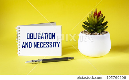 COMMITMENT AND NECESSITY. text on notepad and on yellow background with cactus and pen. 105769206