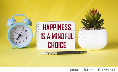 happiness is a mindful choice - text on notepad and yellow background 105769233