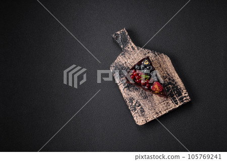 Delicious sweet chocolate brownie cake with blueberries, currants and raspberries Delicious sweet chocolate brownie cake with blueberries, currants and raspberries 105769241