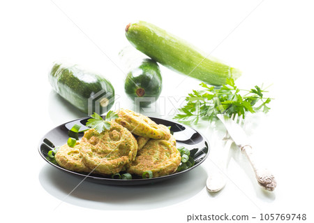 Fried squash green pancakes in a plate. 105769748