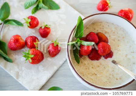 cooked diet oatmeal in a bowl with fresh ripe strawberries cooked diet oatmeal in a bowl with fresh ripe strawberries 105769771