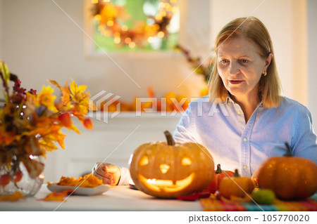 Family carving pumpkin for Halloween Family carving pumpkin for Halloween 105770020