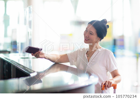 Young Asian woman in airport. Travel by air. Young Asian woman in airport. Travel by air. 105770234