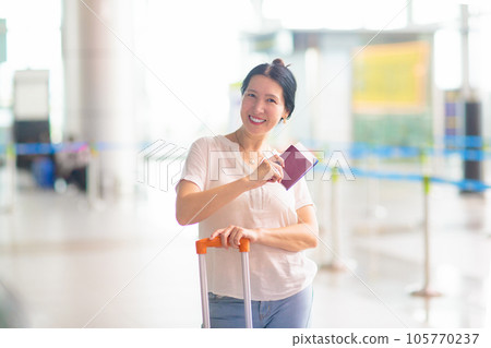 Young Asian woman in airport. Travel by air. Young Asian woman in airport. Travel by air. 105770237