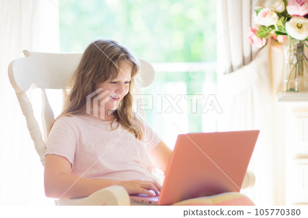 Teenager and computer. Girl chatting with friends. 105770380