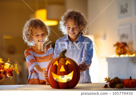 Family carving pumpkin for Halloween 105770450