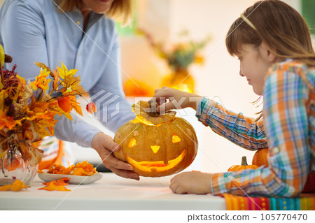 Family carving pumpkin for Halloween 105770470