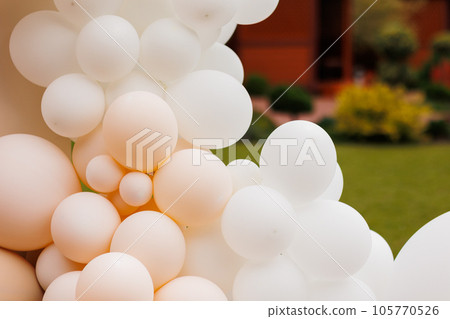Various air balloons of different pastel colours and sizes. Details of creative gender neutral babyshower or birthday party decoration outdoors. Festive photo zone arch kit Various air balloons of different pastel colours and sizes. Details of creative gender neutral babyshower or birthday party decoration outdoors. Festive photo zone arch kit 105770526