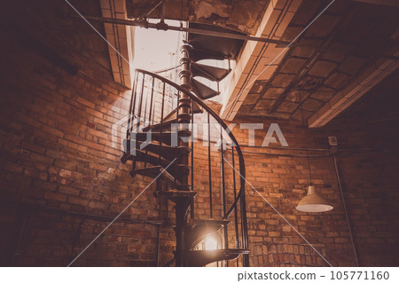 spiral staircase in brick house 105771160