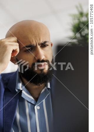 Tired entrepreneurial ceo developing business plan in coworking space. Exhausted company executive manager solving complex task and analyzing financial data on laptop in office 105771408