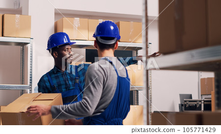 Male manager scanning barcodes on packages in warehouse space, working with scanner and digital tablet to do inventory. Young employee checking stock logistics in industrial department. Male manager scanning barcodes on packages in warehouse space, working with scanner and digital tablet to do inventory. Young employee checking stock logistics in industrial department. 105771429
