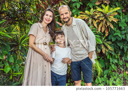 A loving family enjoying a leisurely walk in the park - a radiant pregnant woman after 40, embraced by her husband, and accompanied by their adult teenage son, savoring precious moments together A loving family enjoying a leisurely walk in the park - a radiant pregnant woman after 40, embraced by her husband, and accompanied by their adult teenage son, savoring precious moments together 105771663