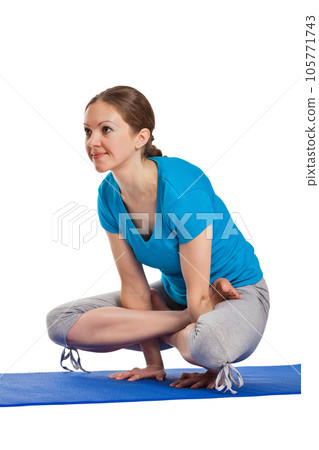 Yoga - young beautiful woman yoga instructor doing Cock Pose (Rooster Posture) (Kukkutasana) asana exercise isolated on white background Yoga - young beautiful woman yoga instructor doing Cock Pose (Rooster Posture) (Kukkutasana) asana exercise isolated on white background 105771743