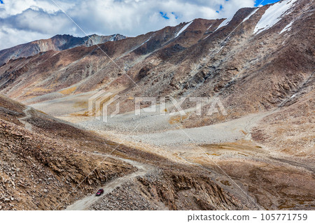 Himalayan valley landscape with road near Kunzum La pass - allegedly the highest motorable pass in the world (5602 m), Ladakh, India 105771759