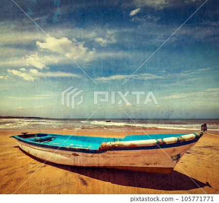 Vintage retro hipster style travel image of boat on a beach, India with grunge texture overlaid Vintage retro hipster style travel image of boat on a beach, India with grunge texture overlaid 105771771