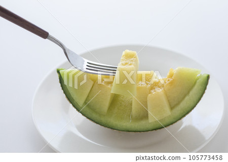 Eating a melon with a fork Eating a melon with a fork 105773458