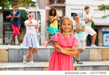 Children exercising contemporary dance moves outdoors Children exercising contemporary dance moves outdoors 105773956