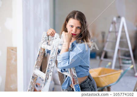 Tempting woman in revealing attire posing in construction site Tempting woman in revealing attire posing in construction site 105774102