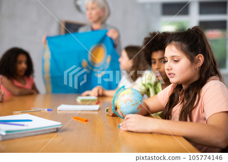 students listen to woman teacher who talks about Kazakhstan students listen to woman teacher who talks about Kazakhstan 105774146