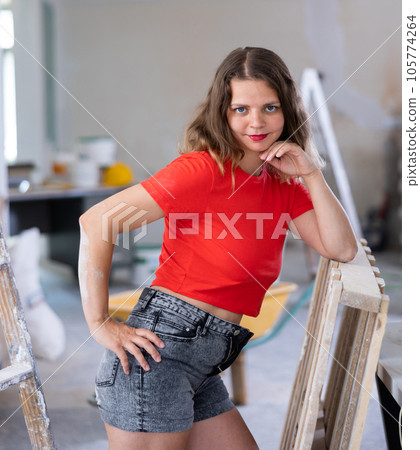 Young seductive woman posing in apartment during repair works Young seductive woman posing in apartment during repair works 105774264