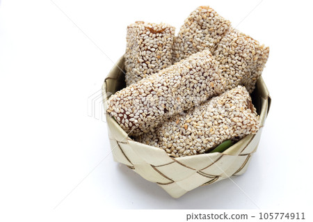 White sesame rolls with peanut. Sweetened dessert White sesame rolls with peanut. Sweetened dessert 105774911
