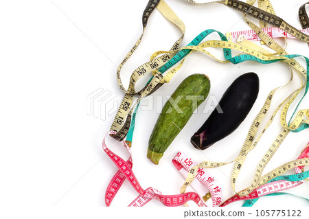Zucchini and eggplant with measuring tape on white background Zucchini and eggplant with measuring tape on white background 105775122