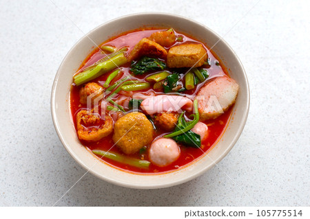 A bowl of pink flat noodles 105775514