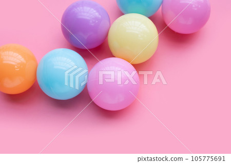Colorful balls on pink background. Colorful balls on pink background. 105775691