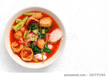 A bowl of pink flat noodles 105775765