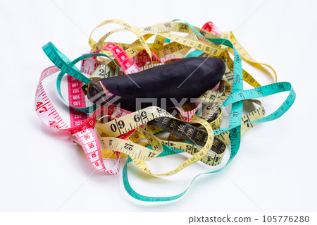 Eggplant with measuring tape on white background. Eggplant with measuring tape on white background. 105776280
