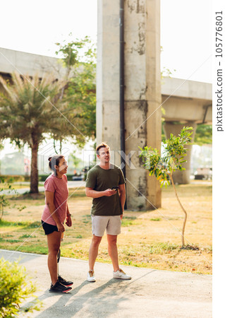 Friend support Friend with a prosthetic leg while exercising outdoor. 105776801