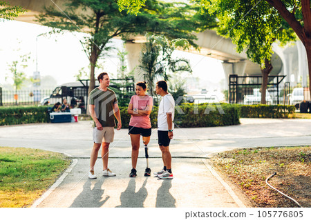 Friend support Friend with a prosthetic leg while exercising outdoor 105776805