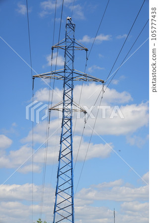 Photo of an electric tower against a blue sky. high voltage post. High voltage tower  105777438