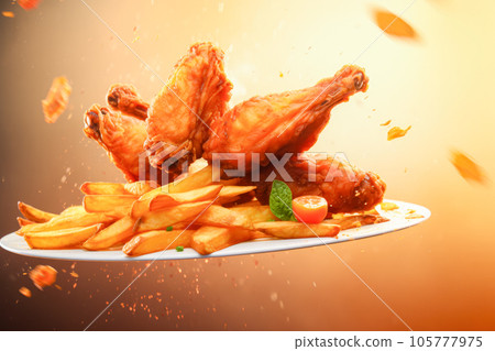 Fried chicken wings flying in the air 105777975