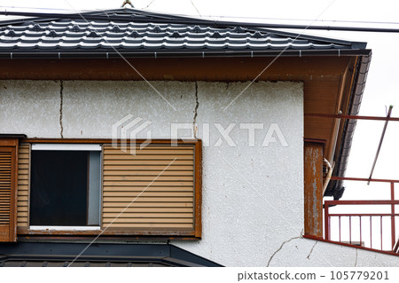 Cracks in the exterior wall paint of the house Cracks in the exterior wall paint of the house 105779201